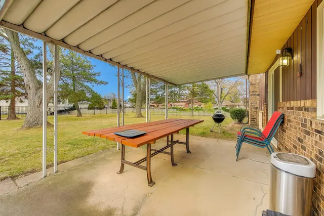 a backyard of a house with outdoor seating