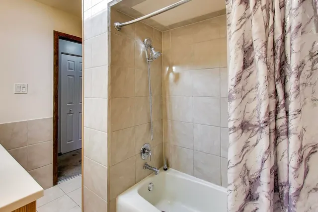 a bathroom with a bathtub and shower