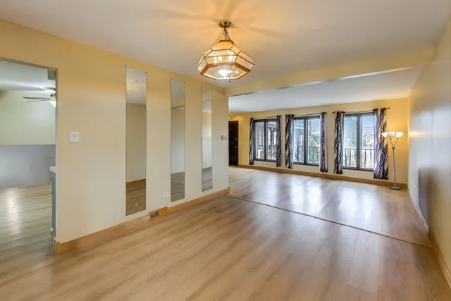 a view of an room with wooden floor and windows