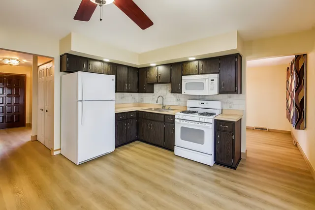 a kitchen with stainless steel appliances a refrigerator sink and stove
