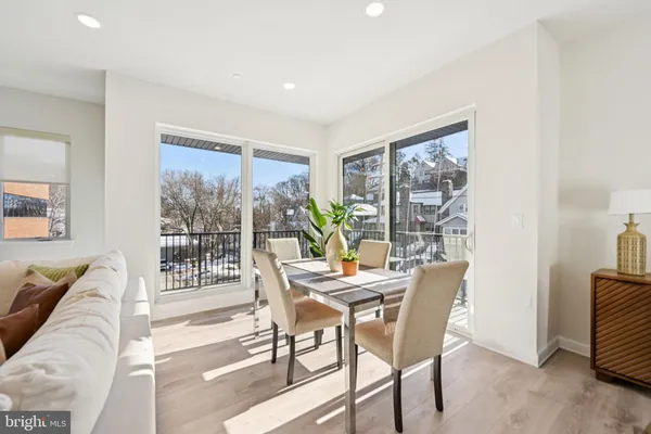 a dining room with furniture and a floor to ceiling window