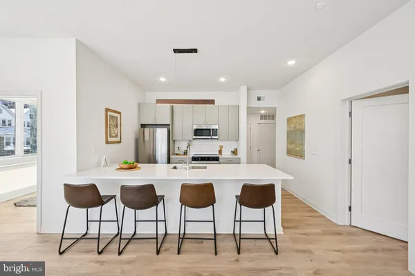 a large kitchen with a table and chairs