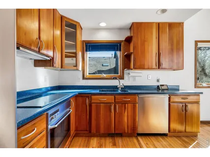 a kitchen with stainless steel appliances granite countertop cabinets and wooden floor