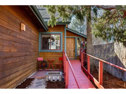 a balcony with wooden floor and outdoor seating