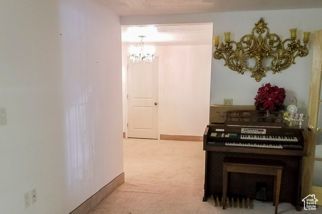 2855 South 1000 West Perry, UT 84302 - Photo 32 of 142 Corridor with a chandelier and light colored carpet