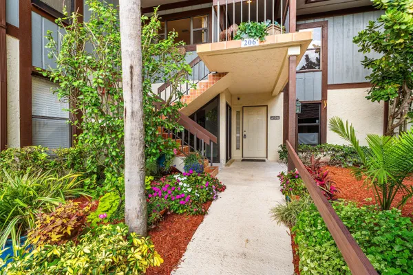 a view of a house with potted plants