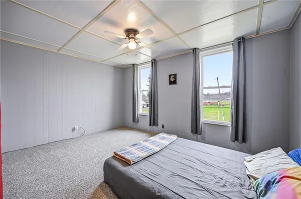 a bedroom with a large bed and a chandelier