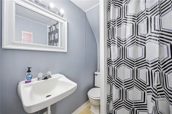 a bathroom with a sink a mirror and a toilet
