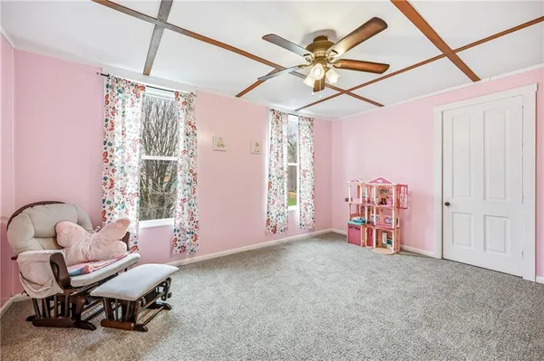 a view of a livingroom with furniture and a ceiling fan