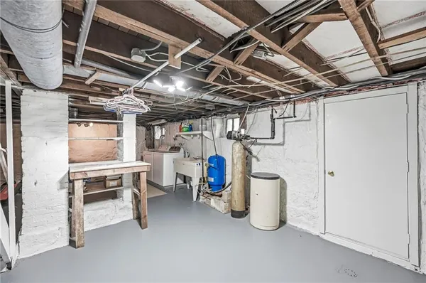 a view of water heater room with wooden ceiling