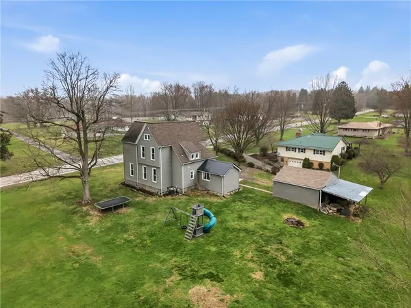 a backyard of a house with table and chairs
