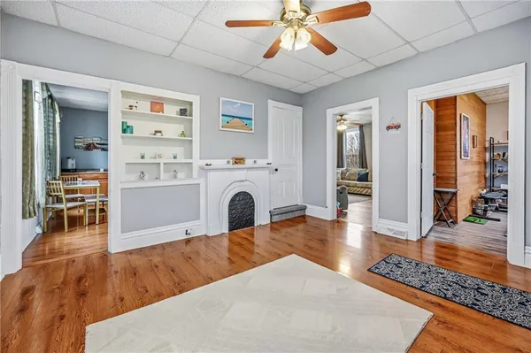 a living room with furniture a fireplace and wooden floor
