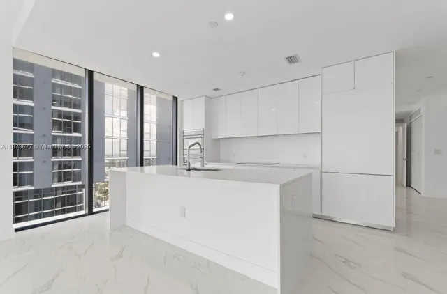 a view of kitchen with stainless steel appliances refrigerator and microwave