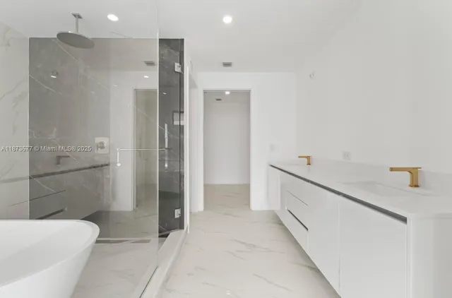 a bathroom with a bathtub and shower