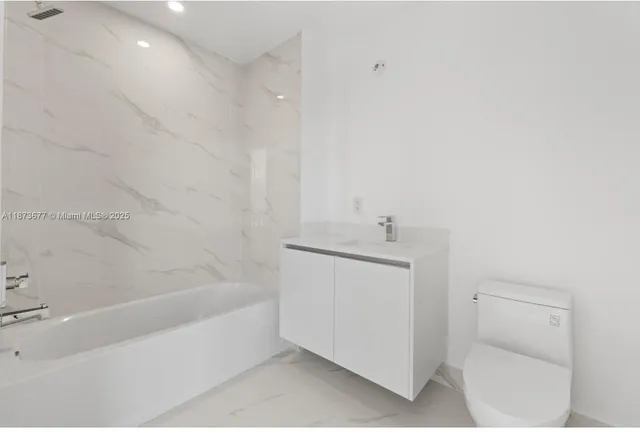 a bathroom with a bathtub sink and toilet