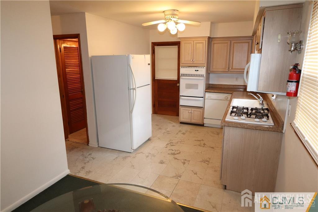 101 Stelton Road Piscataway, NJ 08854 - Photo 4 of 16 a view of kitchen with refrigerator and cabinets