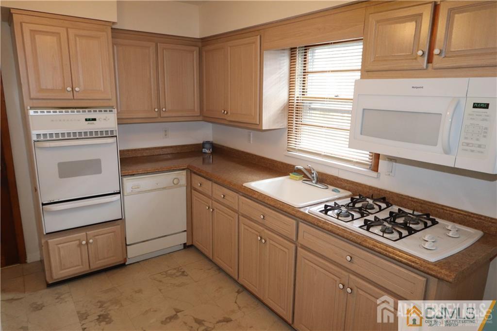101 Stelton Road Piscataway, NJ 08854 - Photo 5 of 16 a kitchen with white cabinets and white appliances
