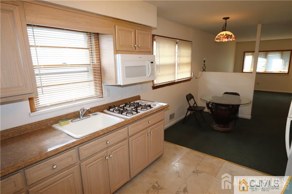101 Stelton Road Piscataway, NJ 08854 - Photo 10 of 16 a kitchen with a sink cabinets and window