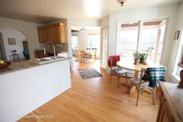 a living room with furniture a wooden floor and a large window