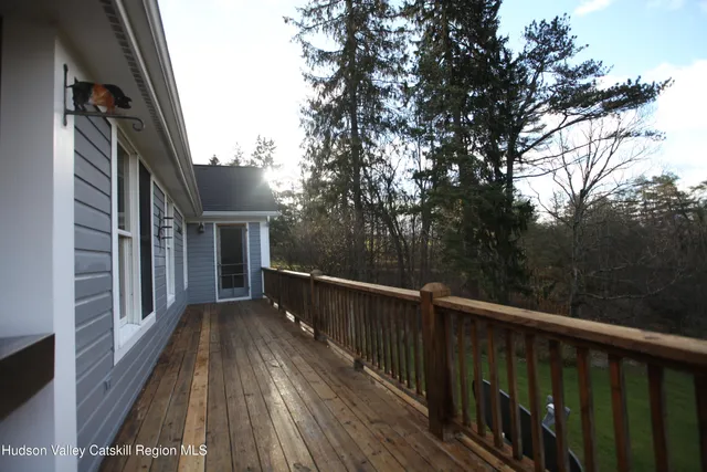 a view of balcony with wooden floor and fence
