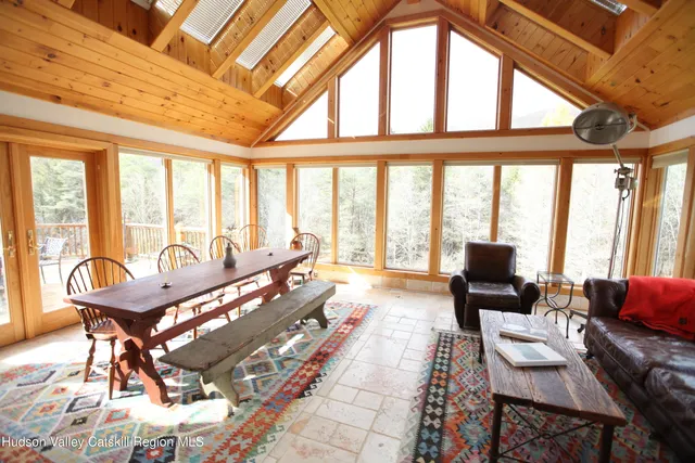 a living room with furniture and a floor to ceiling window