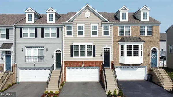 a front view of a residential apartment building with a yard