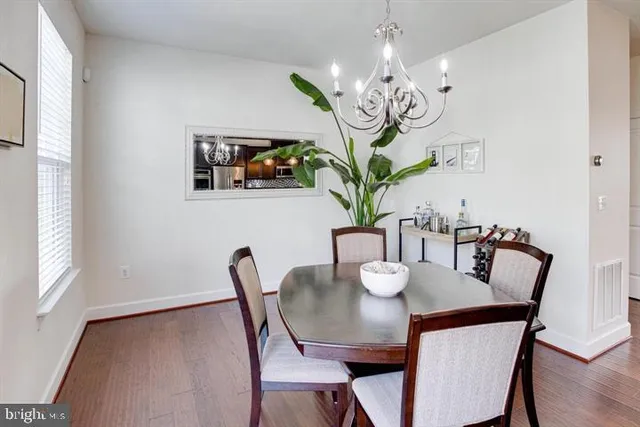 a view of a dining room with furniture wooden floor and chandelier