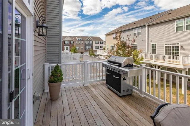 a view of a living room and balcony with furniture