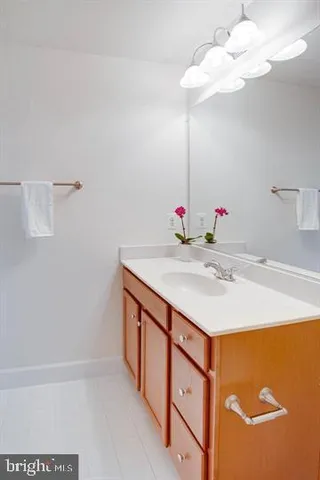 a bathroom with a sink a mirror and a shower