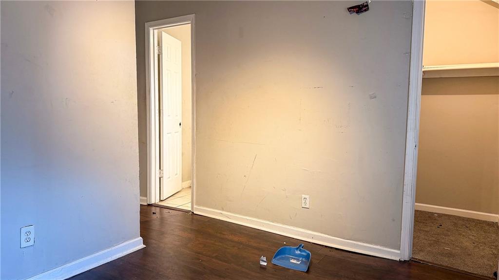 1188 Sims Street Southwest Atlanta, GA 30310 - Photo 3 of 17 an empty room with wooden floor and closet