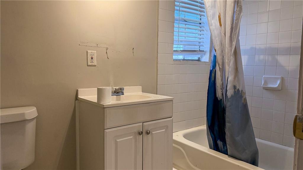 1188 Sims Street Southwest Atlanta, GA 30310 - Photo 4 of 17 a bathroom with a sink a toilet and shower