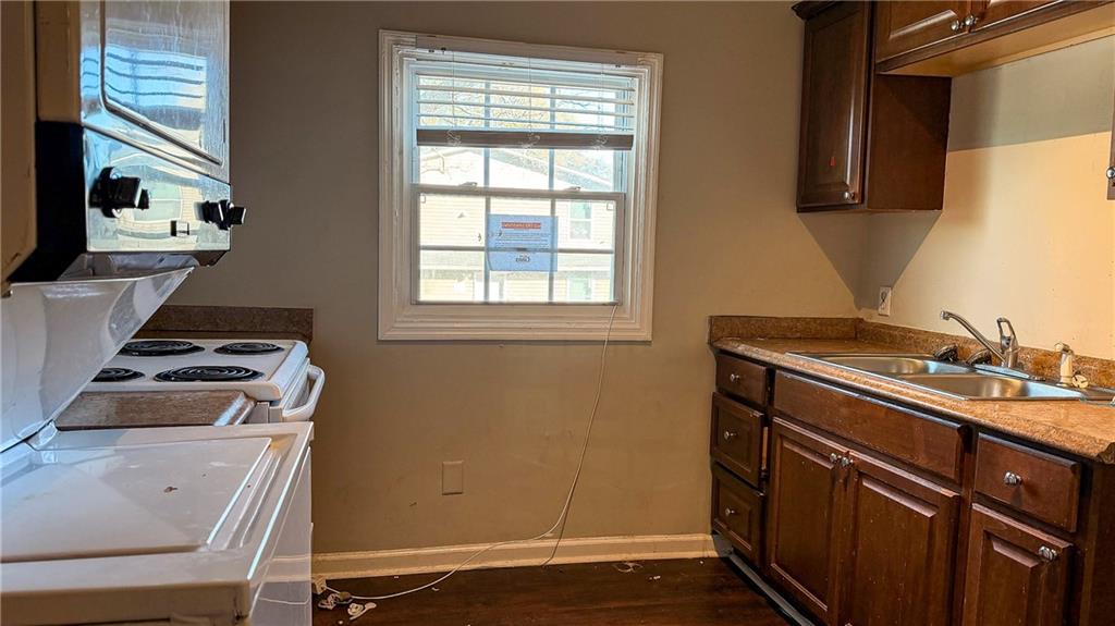 1188 Sims Street Southwest Atlanta, GA 30310 - Photo 7 of 17 a kitchen with a stove and a sink