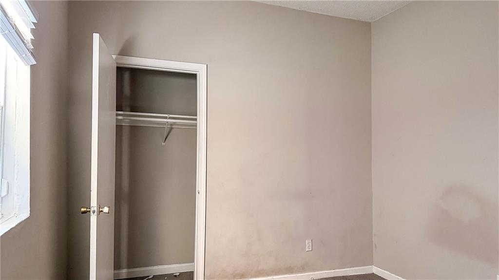 1188 Sims Street Southwest Atlanta, GA 30310 - Photo 10 of 17 a view of walk in closet with empty racks