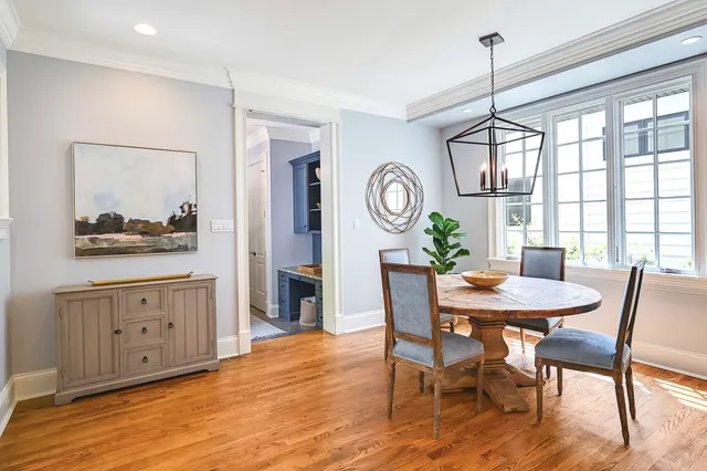 a living room with furniture a rug and a book shelf