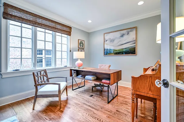 a view of staircase with lots of frames and a rug