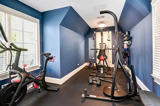 a bedroom with a bed and a lamp next to a window