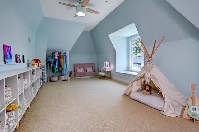 a living room with baby crib and furniture