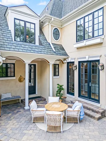 a backyard of a house with table and chairs