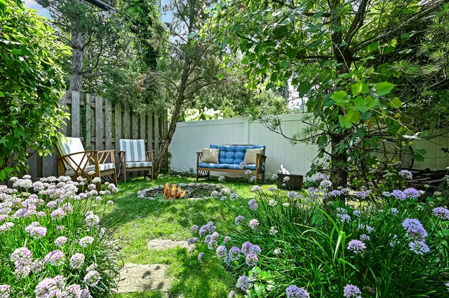 a view of a chairs and table in backyard of the house