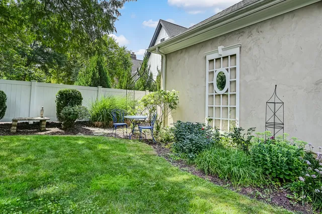 a view of a backyard with table and chairs and potted plants