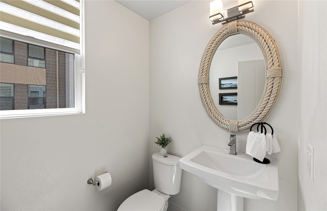 1675 Grand View Costa Mesa, CA 92627 - Photo 17 of 35 a bathroom with a toilet mirror and vanity