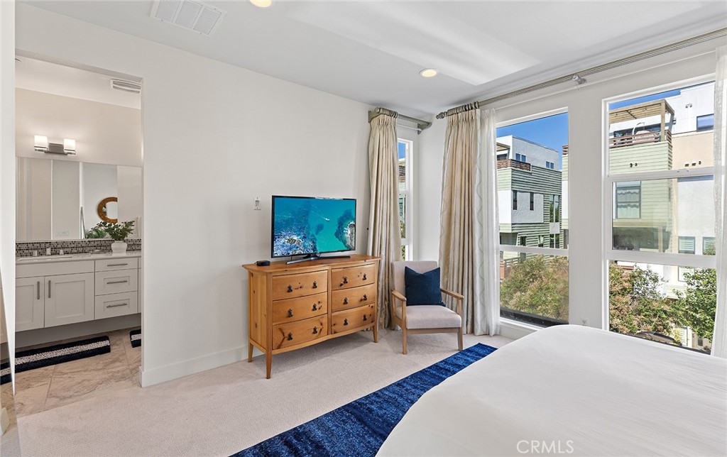 1675 Grand View Costa Mesa, CA 92627 - Photo 19 of 35 a bedroom with a bed and a dresser