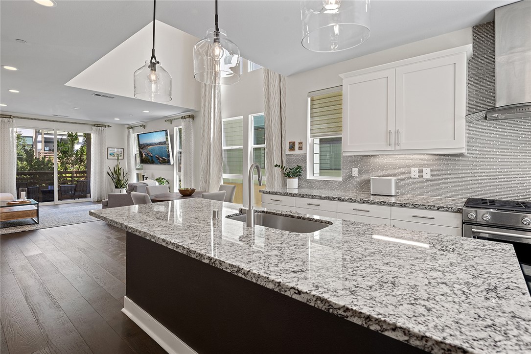 1675 Grand View Costa Mesa, CA 92627 - Photo 6 of 35 a kitchen with granite countertop a sink a counter top space and cabinets