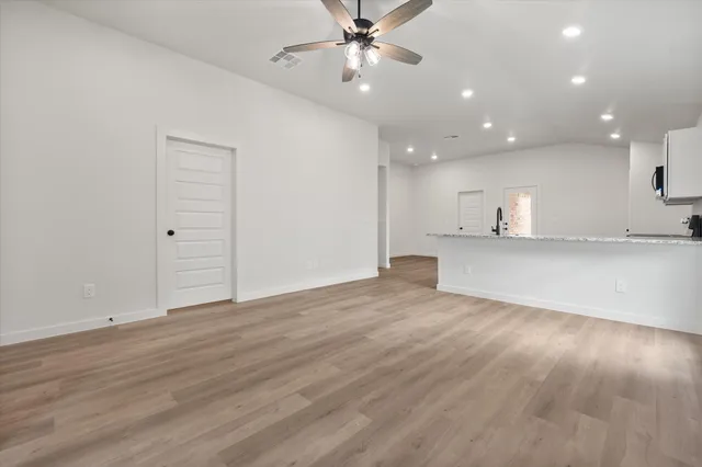a view of a kitchen with a sink and a window