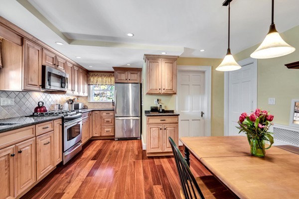 19 Pierrepont Road Winchester, MA 01890 - Photo 3 of 23 a kitchen with stainless steel appliances kitchen island granite countertop a stove refrigerator and cabinets
