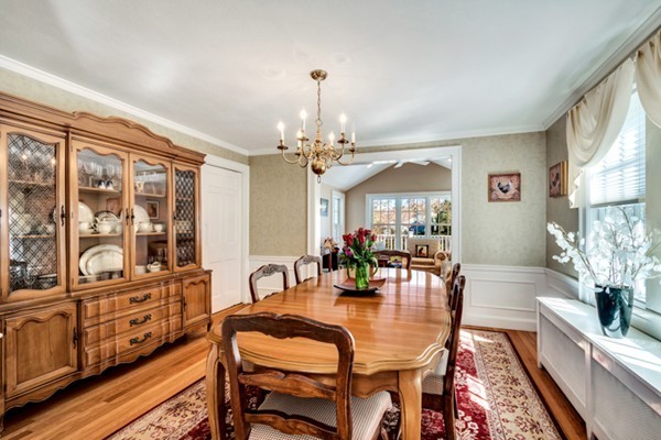 19 Pierrepont Road Winchester, MA 01890 - Photo 9 of 23 a dining room with wooden floor a chandelier a wooden table and chairs