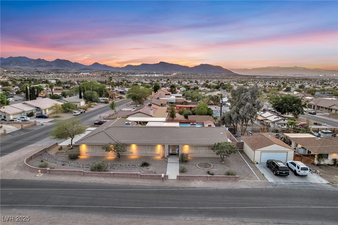 Aerial view at dusk featuring a mountain view and a residential view