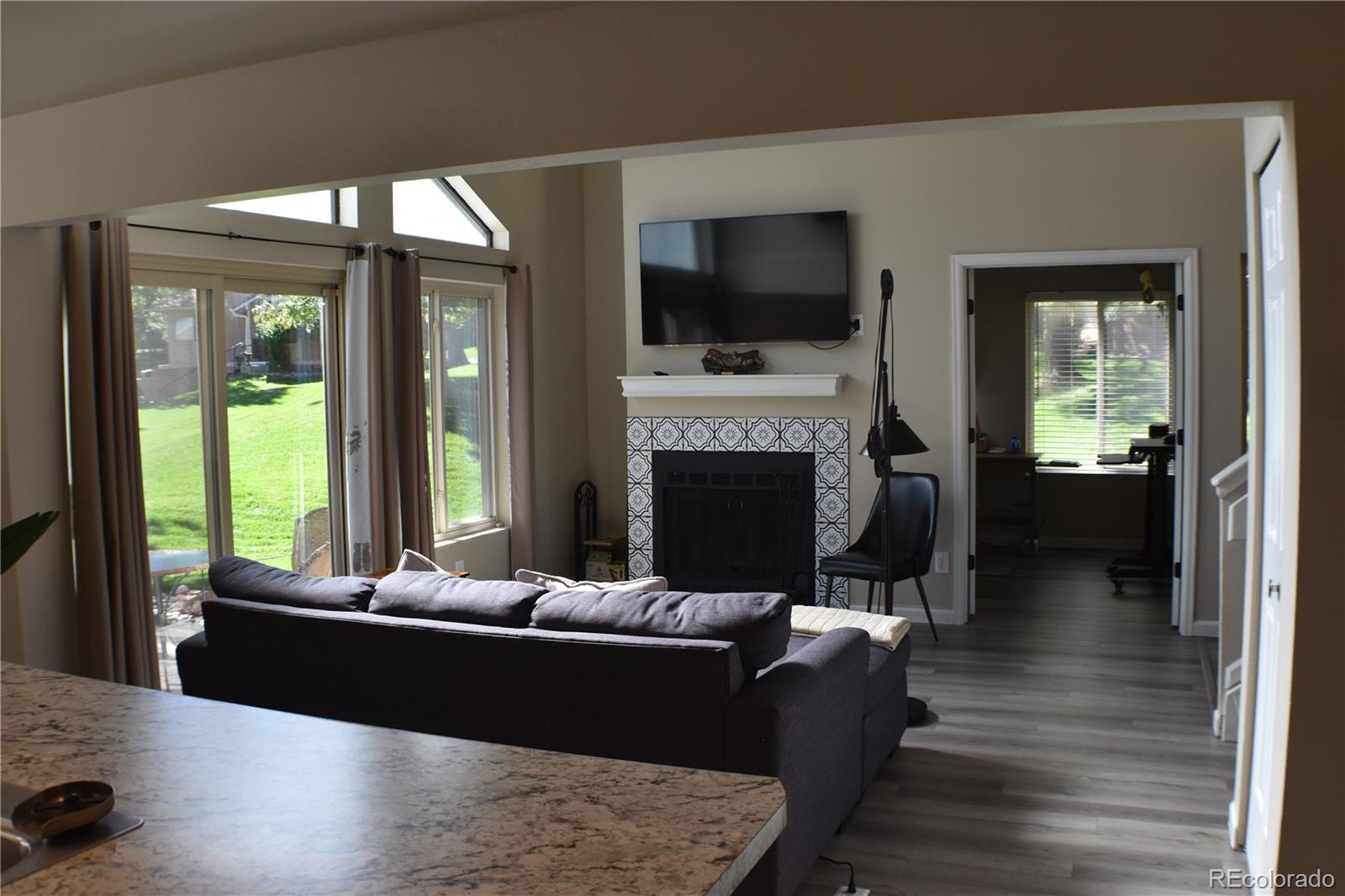 4075 Autumn Heights Drive, Unit F Colorado Springs, CO 80906 - Photo 11 of 44 a living room with furniture a flat screen tv and a fireplace