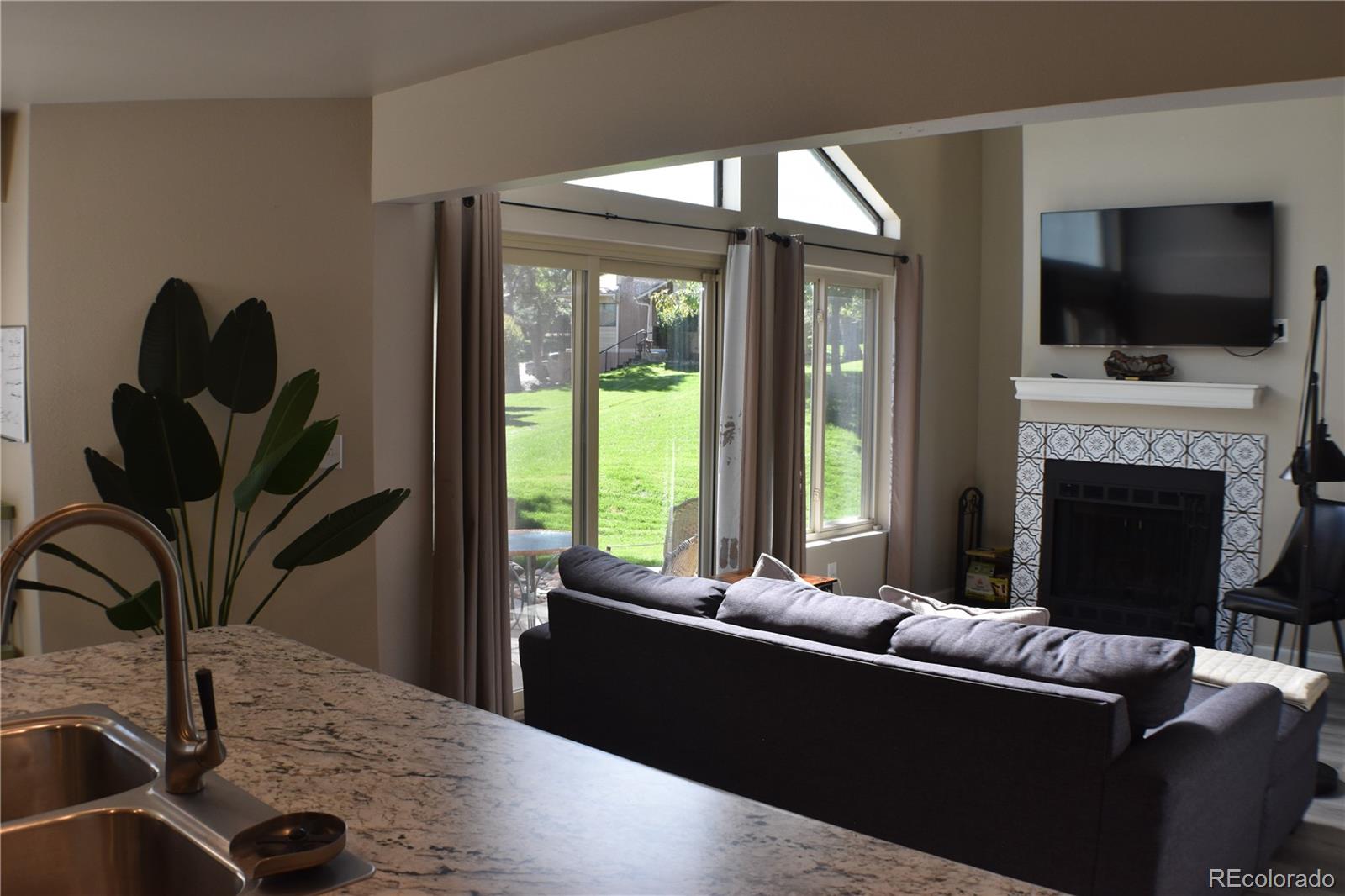 4075 Autumn Heights Drive, Unit F Colorado Springs, CO 80906 - Photo 12 of 44 a living room with furniture a flat screen tv and a fireplace