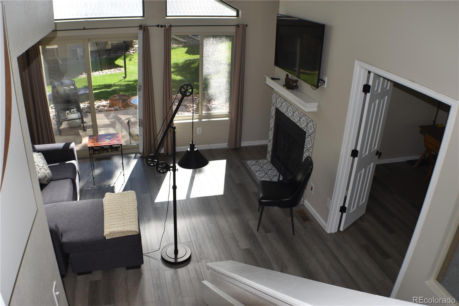 4075 Autumn Heights Drive, Unit F Colorado Springs, CO 80906 - Photo 18 of 44 a living room with furniture a flat screen tv and a floor to ceiling window
